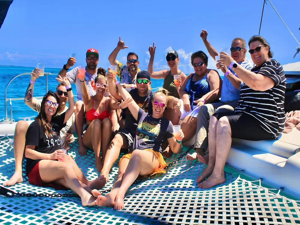 A large group of happy tourist making toast in route to Isla Mujeres a board of catamaran from Cancun