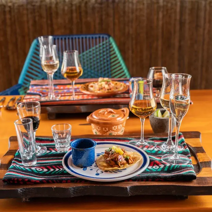 At the restaurant Lighthouse, tacos al pastor and several glasses of tequila are served.